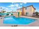 Backyard pool features a slide, in-pool floats, patio seating, and privacy fence at 7018 Berkshire Pl, Las Vegas, NV 89147