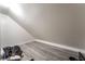 This bonus room is an unfinished room with wood floors and a slanted roof at 7018 Berkshire Pl, Las Vegas, NV 89147