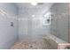 Modern walk-in shower with shower head and marble floors at 7018 Berkshire Pl, Las Vegas, NV 89147