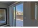 This balcony has a sliding glass door with privacy curtains and a view of the community at 7175 Steubling Glen St, North Las Vegas, NV 89084