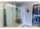 Bright bathroom showcases a walk-in shower with a glass surround and a walk-in closet at 7175 Steubling Glen St, North Las Vegas, NV 89084