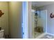 Bright bathroom features a walk-in shower with a glass surround, a shower caddy and a modern seat at 7175 Steubling Glen St, North Las Vegas, NV 89084