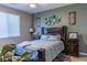 Well-lit bedroom features a wooden bed frame, large window, and contemporary decor at 7175 Steubling Glen St, North Las Vegas, NV 89084