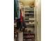 Walk-in closet has custom built-ins, shelving, and shoe racks at 7175 Steubling Glen St, North Las Vegas, NV 89084