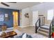 A bright and inviting entryway with stylish decor, wood-look flooring and staircase at 7175 Steubling Glen St, North Las Vegas, NV 89084