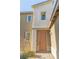 Inviting front entrance featuring a stylish salmon-colored door with a textured exterior and adjacent garden at 7175 Steubling Glen St, North Las Vegas, NV 89084