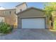 Charming home featuring a spacious two-car garage with a paved driveway and well-maintained landscaping at 7175 Steubling Glen St, North Las Vegas, NV 89084