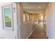 Bright hallway with a large window, neutral paint and carpeted floors at 7175 Steubling Glen St, North Las Vegas, NV 89084