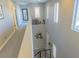 Bright hallway featuring decor shelves and stairwell access, complemented by natural light from multiple windows at 7175 Steubling Glen St, North Las Vegas, NV 89084