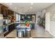 Spacious kitchen with dark cabinets, granite countertops, a kitchen island, and an open floor plan at 7175 Steubling Glen St, North Las Vegas, NV 89084