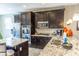 Well-equipped kitchen featuring dark cabinets, stainless steel appliances, and an island with a sink at 7175 Steubling Glen St, North Las Vegas, NV 89084