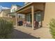 Backyard patio features a cozy seating area and grill, surrounded by a low-maintenance desert landscape at 7175 Steubling Glen St, North Las Vegas, NV 89084