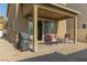 Outdoor patio space with comfortable seating, a barbeque, and desert landscaping in the backyard at 7175 Steubling Glen St, North Las Vegas, NV 89084