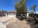Modest single story home with an attached two car garage and mature trees at 7300 Mountain Moss Dr, Las Vegas, NV 89147
