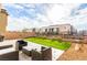 Serene backyard with modern seating, artificial turf, and low-maintenance landscaping providing a private outdoor space at 7733 Rosebark Cliffs St, North Las Vegas, NV 89084