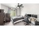 Bedroom with a ceiling fan, carpet, and a window providing natural light at 7733 Rosebark Cliffs St, North Las Vegas, NV 89084