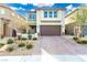 Charming two-story home featuring a brick-paved driveway and a well-maintained, drought-resistant landscaped yard at 7733 Rosebark Cliffs St, North Las Vegas, NV 89084