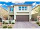 Charming two-story home featuring a brick-paved driveway and a well-maintained, drought-resistant landscaped yard at 7733 Rosebark Cliffs St, North Las Vegas, NV 89084