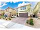 Charming two-story home featuring a brick-paved driveway and a well-maintained, drought-resistant landscaped yard at 7733 Rosebark Cliffs St, North Las Vegas, NV 89084