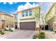 Charming two-story home featuring a brick-paved driveway and a well-maintained, drought-resistant landscaped yard at 7733 Rosebark Cliffs St, North Las Vegas, NV 89084