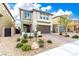 Charming two-story home featuring a brick-paved driveway and a well-maintained, drought-resistant landscaped yard at 7733 Rosebark Cliffs St, North Las Vegas, NV 89084