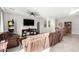Spacious living room featuring neutral paint, a ceiling fan, and plush seating for entertaining at 7733 Rosebark Cliffs St, North Las Vegas, NV 89084