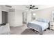 Spacious main bedroom with a ceiling fan, plush carpet, and en-suite bathroom with walk-in shower at 7733 Rosebark Cliffs St, North Las Vegas, NV 89084
