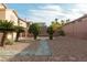 The backyard features rock landscaping, trees, and neighboring properties at 787 Craigmark Ct, Henderson, NV 89002
