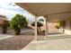 Enjoy the backyard with trees, gravel landscaping, and a covered patio at 787 Craigmark Ct, Henderson, NV 89002