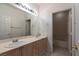 Bright bathroom with double sinks, large mirror and bathtub in separate room at 787 Craigmark Ct, Henderson, NV 89002