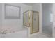 Bright bathroom featuring a soaking tub and a glass-enclosed shower at 787 Craigmark Ct, Henderson, NV 89002