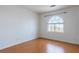 Bedroom with laminate floor and arched window with outdoor view at 787 Craigmark Ct, Henderson, NV 89002