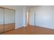 Bedroom with laminate floor and mirrored closet with an open door at 787 Craigmark Ct, Henderson, NV 89002