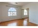 Bedroom with laminate flooring, arched window, and mirrored closet at 787 Craigmark Ct, Henderson, NV 89002