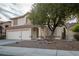 Inviting home exterior with a spacious driveway, mature trees, and a well-maintained lawn at 787 Craigmark Ct, Henderson, NV 89002