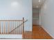Upstairs hallway with hardwood floors and matching wood handrail at 787 Craigmark Ct, Henderson, NV 89002