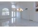 Bright, open living room with tile floors, soaring ceilings, and large windows at 787 Craigmark Ct, Henderson, NV 89002
