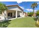 Low-maintenance backyard featuring artificial grass, a covered patio, and desert landscaping at 8232 Silver Vine St, North Las Vegas, NV 89085