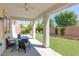 Relaxing covered patio features a ceiling fan, outdoor seating and view of the green backyard at 8232 Silver Vine St, North Las Vegas, NV 89085