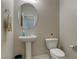 Powder room featuring a pedestal sink and toilet at 8232 Silver Vine St, North Las Vegas, NV 89085