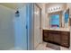 Bathroom featuring a glass-door shower and dark wood vanity at 8232 Silver Vine St, North Las Vegas, NV 89085