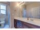 Bathroom featuring a large mirror and dark wood vanity with white countertop at 8232 Silver Vine St, North Las Vegas, NV 89085