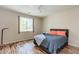 Bedroom with wood-look flooring, ceiling fan, and window at 8232 Silver Vine St, North Las Vegas, NV 89085