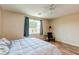 Cozy bedroom with laminate floors, natural light, and a comfortable chair at 8232 Silver Vine St, North Las Vegas, NV 89085
