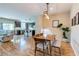 The dining area features hardwood floors, a modern light fixture, and seamless access to the open kitchen at 8232 Silver Vine St, North Las Vegas, NV 89085