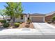 Charming single-story home featuring a tile roof, neutral stucco, and a manicured, low-maintenance front yard at 8232 Silver Vine St, North Las Vegas, NV 89085