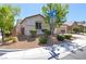 Landscaped single-story home featuring low-maintenance desert landscaping, a tile roof, and a two-car garage at 8232 Silver Vine St, North Las Vegas, NV 89085