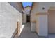 Side view of home featuring stucco walls, a tile roof, and a walkway leading to the front door at 8232 Silver Vine St, North Las Vegas, NV 89085