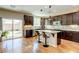 Modern kitchen featuring an island with bar seating and a sliding glass door to the backyard at 8232 Silver Vine St, North Las Vegas, NV 89085