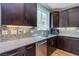 The kitchen features granite countertops, a tile backsplash, a stainless steel dishwasher, and dark cabinetry at 8232 Silver Vine St, North Las Vegas, NV 89085